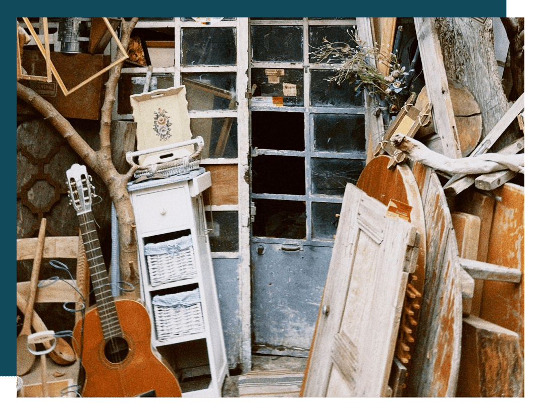 A room with many old doors and a guitar